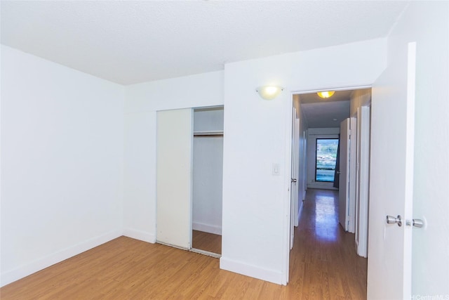 87-118 Helelua St Unit B101, Waianae, HI 96792 - unfurnished bedroom with baseboards, a closet, and light wood-type flooring