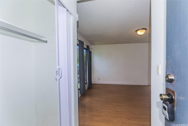 87-118 Helelua St Unit B101, Waianae, HI 96792 - corridor with baseboards, a textured ceiling, and wood finished floors