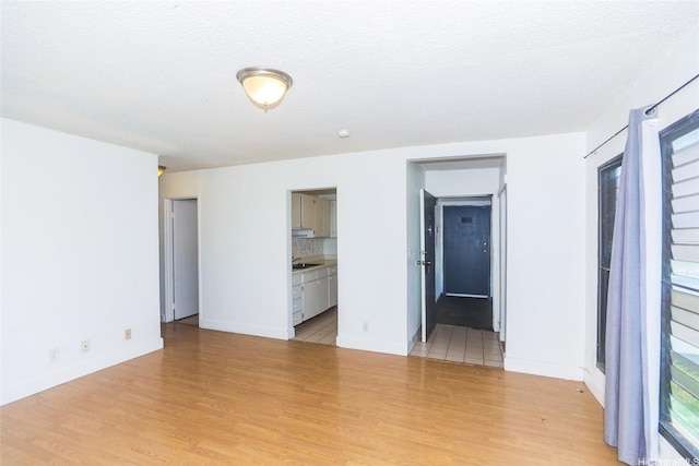 87-118 Helelua St Unit B101, Waianae, HI 96792 - interior space featuring light wood-style flooring and baseboards