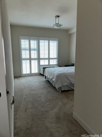 bedroom featuring dark carpet