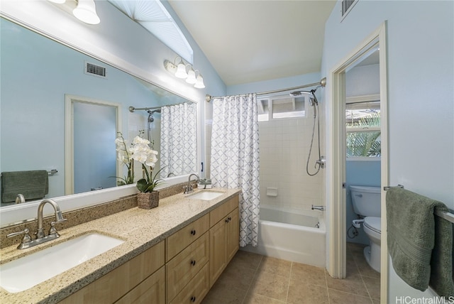 full bathroom featuring lofted ceiling, tile patterned flooring, vanity, shower / bath combination with curtain, and toilet