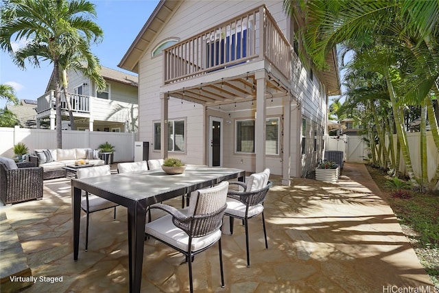 view of patio featuring an outdoor living space and a balcony