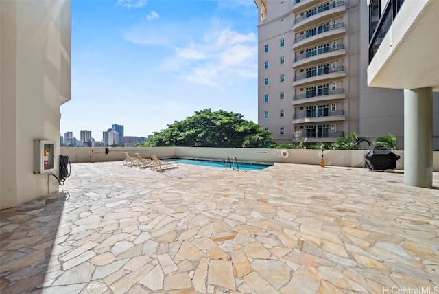 view of pool featuring a patio area