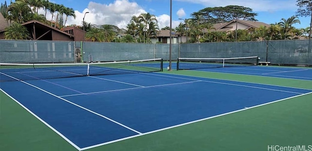 view of tennis court with basketball hoop