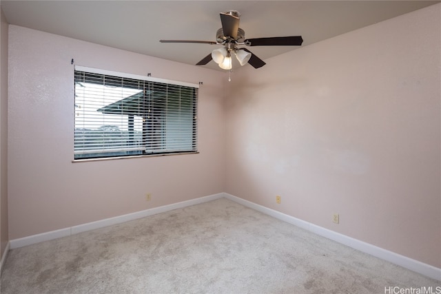 carpeted spare room featuring ceiling fan