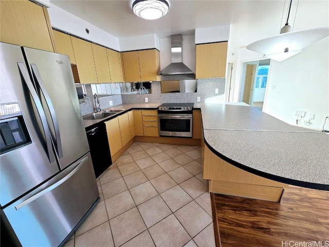 kitchen featuring decorative backsplash, appliances with stainless steel finishes, kitchen peninsula, sink, and wall chimney range hood