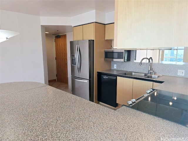 kitchen with tasteful backsplash, light brown cabinetry, sink, and stainless steel appliances