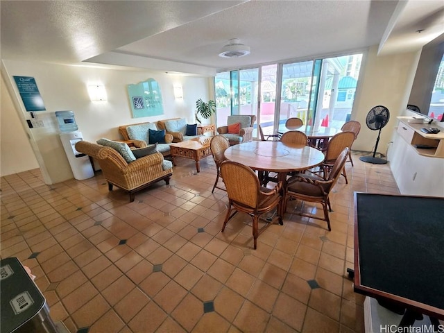 tiled dining space with a textured ceiling