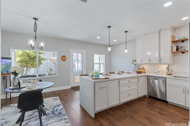 kitchen featuring white cabinets, dishwasher, and kitchen peninsula