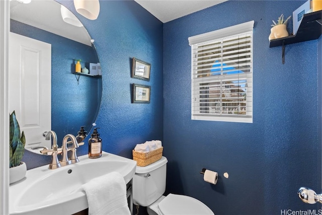 bathroom featuring sink and toilet