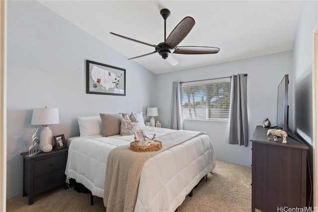 carpeted bedroom featuring ceiling fan and vaulted ceiling