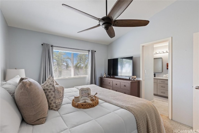 bedroom with ceiling fan, ensuite bathroom, and lofted ceiling