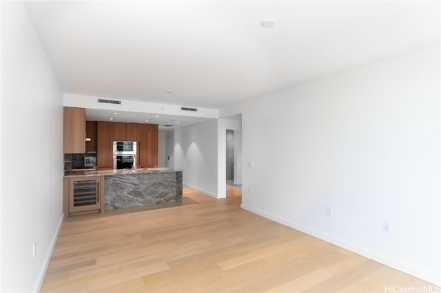 living room with light hardwood / wood-style flooring and wine cooler