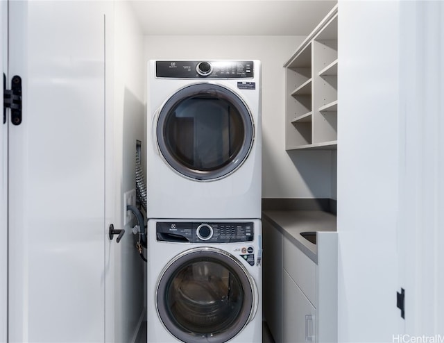 laundry area with stacked washer and clothes dryer