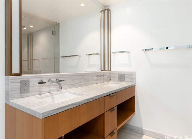 bathroom with decorative backsplash, vanity, and hardwood / wood-style flooring