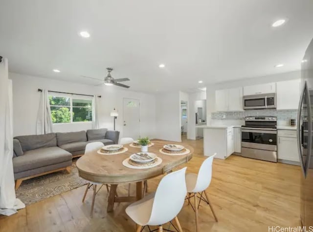 dining room featuring ceiling fan and light wood-type flooring