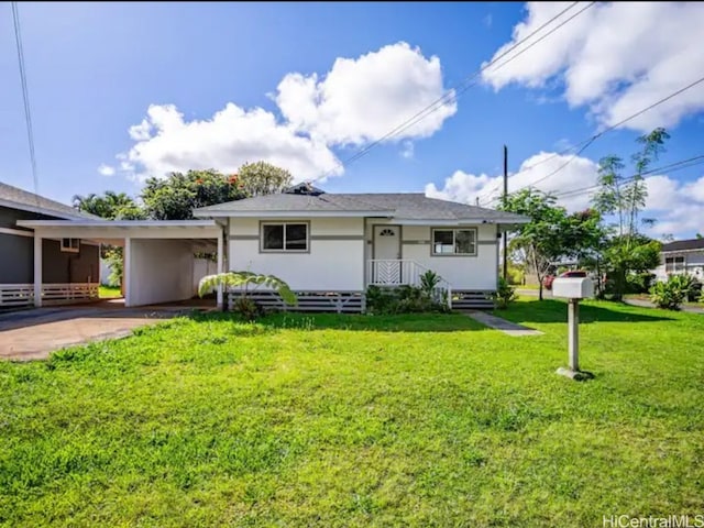 view of front facade with a front lawn and a carport