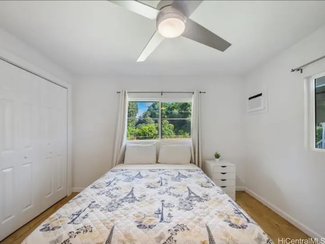 bedroom with a closet, hardwood / wood-style flooring, and ceiling fan