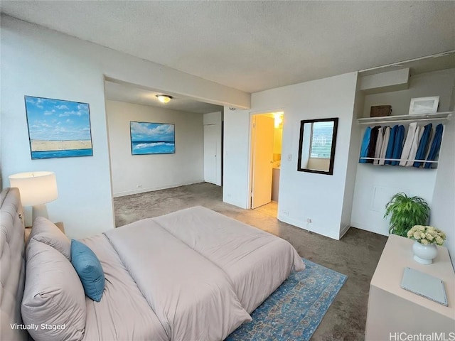 bedroom featuring a textured ceiling and carpet flooring