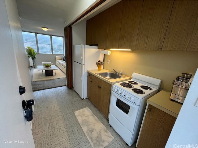 kitchen featuring sink and white appliances