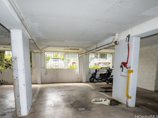 parking garage featuring concrete block wall