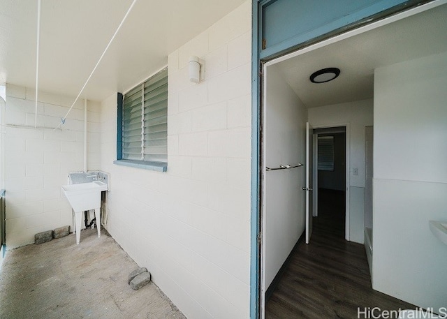 exterior space with hardwood / wood-style flooring and sink