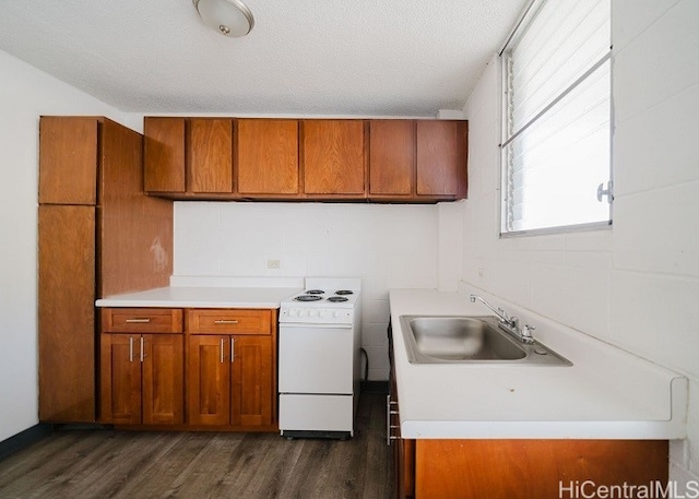 kitchen with sink, dark hardwood / wood-style flooring, white stove, and a textured ceiling