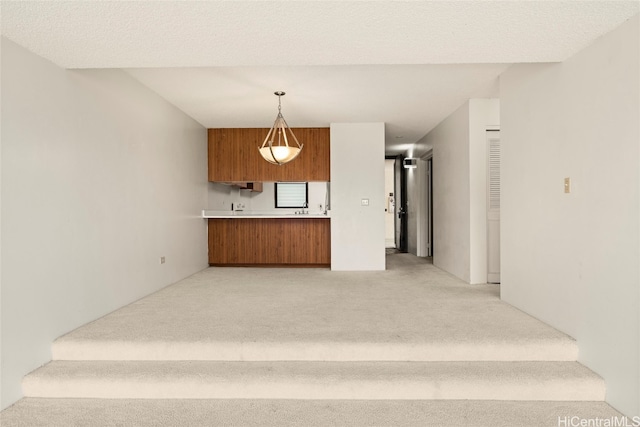 staircase with carpet floors and a textured ceiling