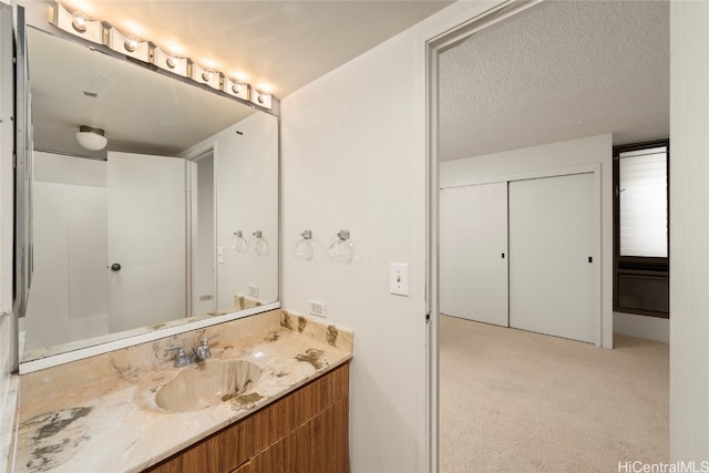 bathroom with vanity and a textured ceiling