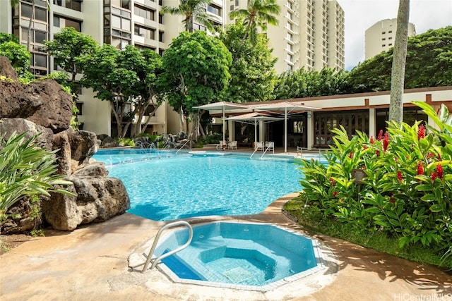 view of swimming pool with a community hot tub