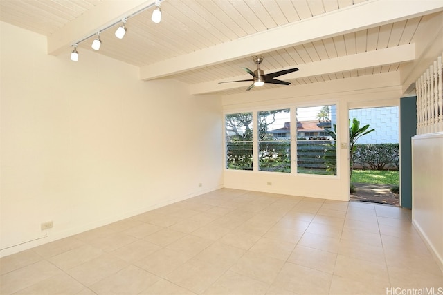 unfurnished room with beamed ceiling and light tile patterned floors