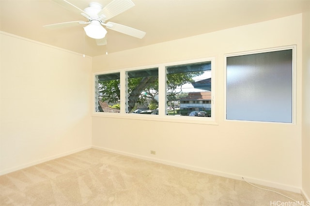 spare room with light carpet and ceiling fan