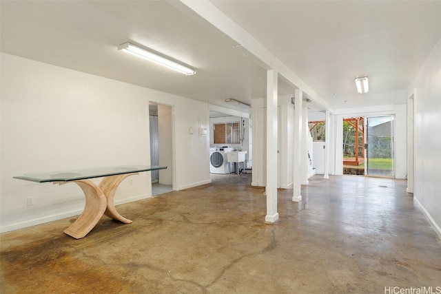 interior space featuring concrete flooring and washer / dryer