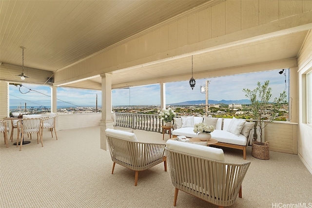 view of patio / terrace with a mountain view and an outdoor hangout area