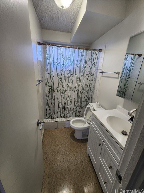 bathroom featuring vanity, a textured ceiling, toilet, and curtained shower