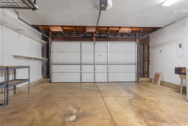 garage with a garage door opener and electric panel