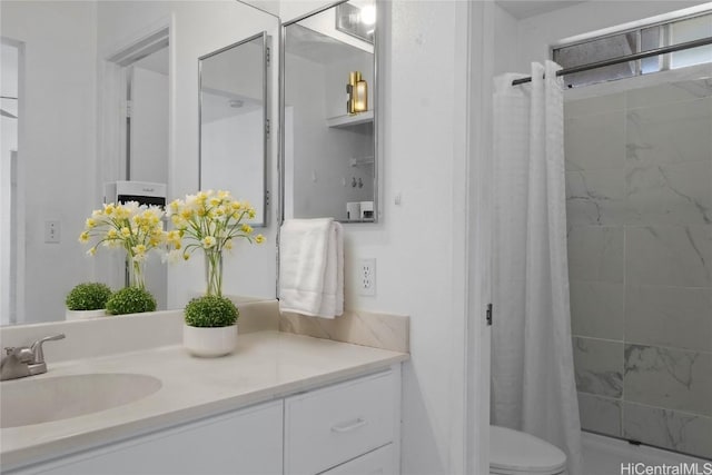 bathroom with vanity, curtained shower, and toilet