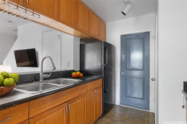 kitchen with black refrigerator and sink