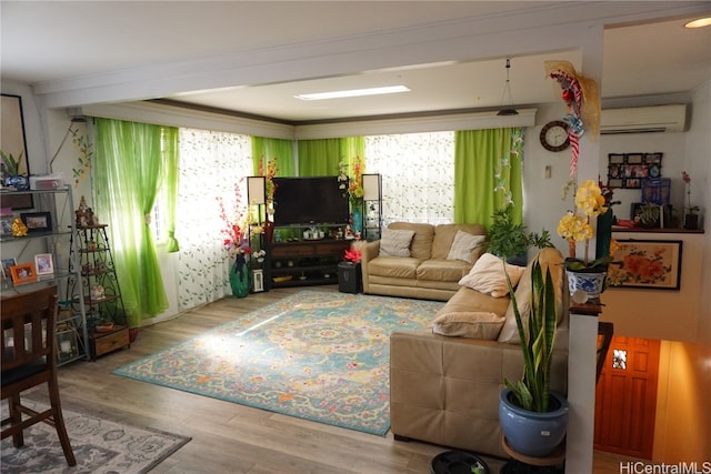 living room with crown molding, hardwood / wood-style floors, and a wall mounted air conditioner