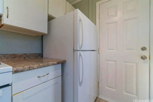 kitchen with white appliances and white cabinetry