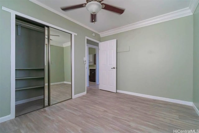 unfurnished bedroom featuring a closet, light hardwood / wood-style flooring, and ceiling fan