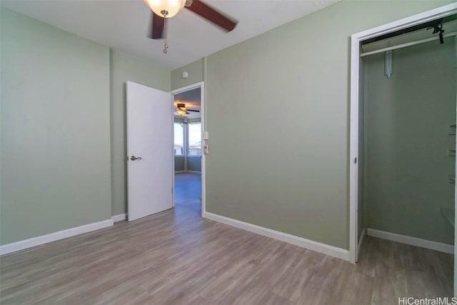 unfurnished bedroom with ceiling fan, a closet, and light hardwood / wood-style floors