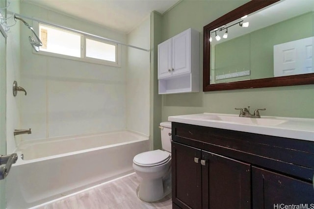 full bathroom featuring toilet, vanity, and washtub / shower combination