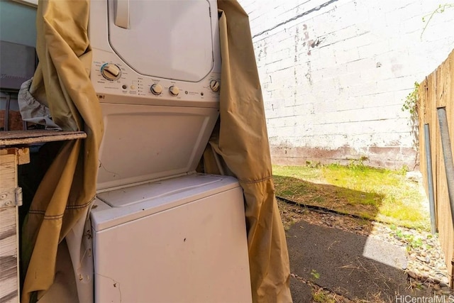 laundry room featuring stacked washing maching and dryer