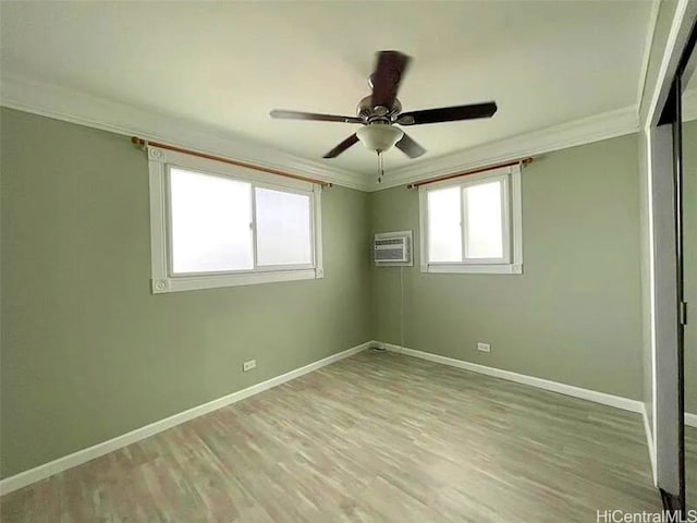 spare room with ceiling fan, light wood-type flooring, and crown molding