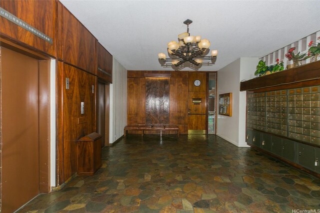 1848 Kahakai Dr Unit 1904, Honolulu, HI 96814 - entrance foyer with mail area, a chandelier, stone finish flooring, and elevator