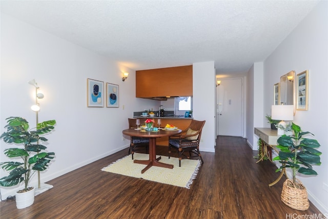 dining room featuring a textured ceiling and dark wood-type flooring