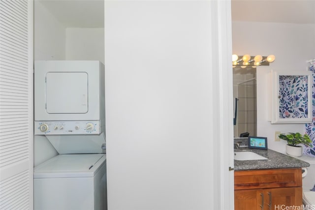 laundry room with stacked washing maching and dryer and sink