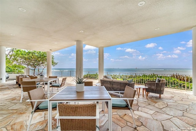 view of patio with a water view