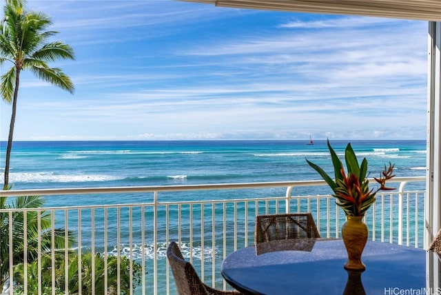 balcony with a view of the beach and a water view